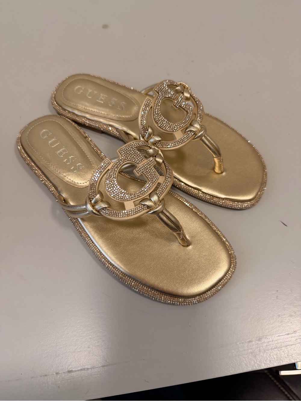 GUESS Gold Metallic Logo Thong Sandals with Crystal Accents